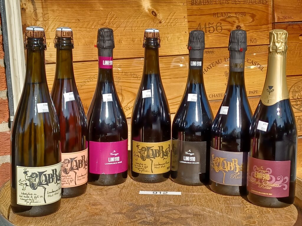 Wine bottles arranged on top of an oak barrel