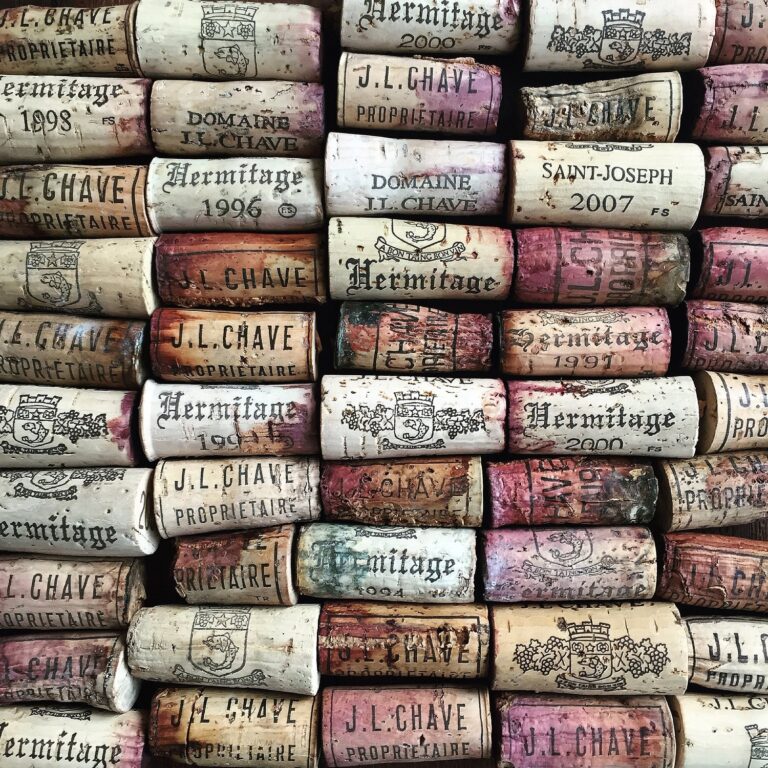 dozens of corks pulled from wine bottles assembled in rows
