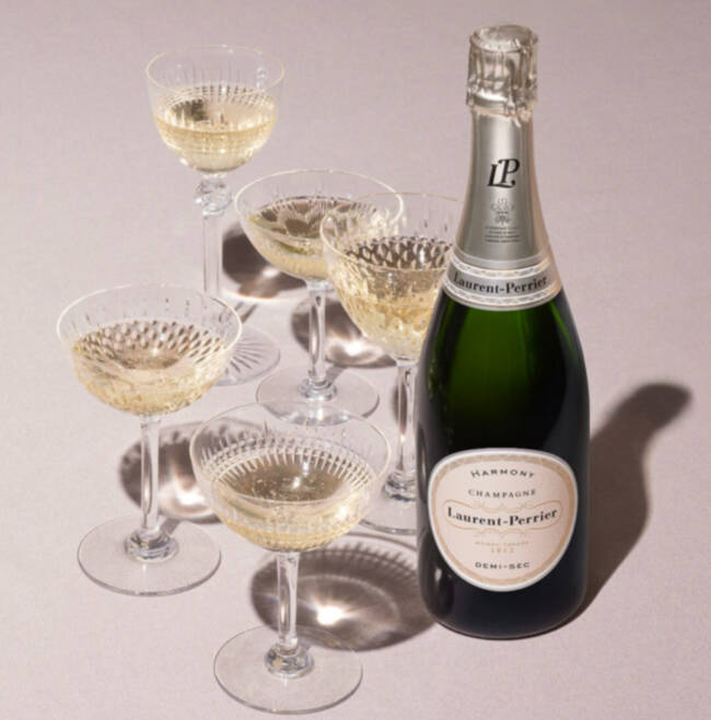 champagne bottle surrounded by glasses