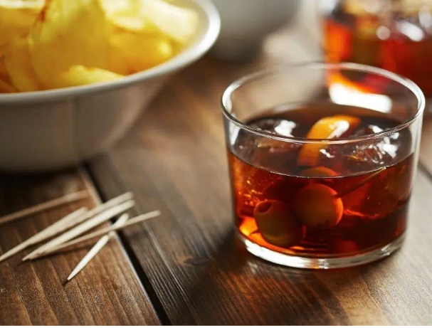 glass with amber liquid and ice